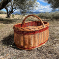 Cesta de mimbre grande con asa, perfecta para almacenamiento y decoración de setas, tamaño mediano y forma circular.